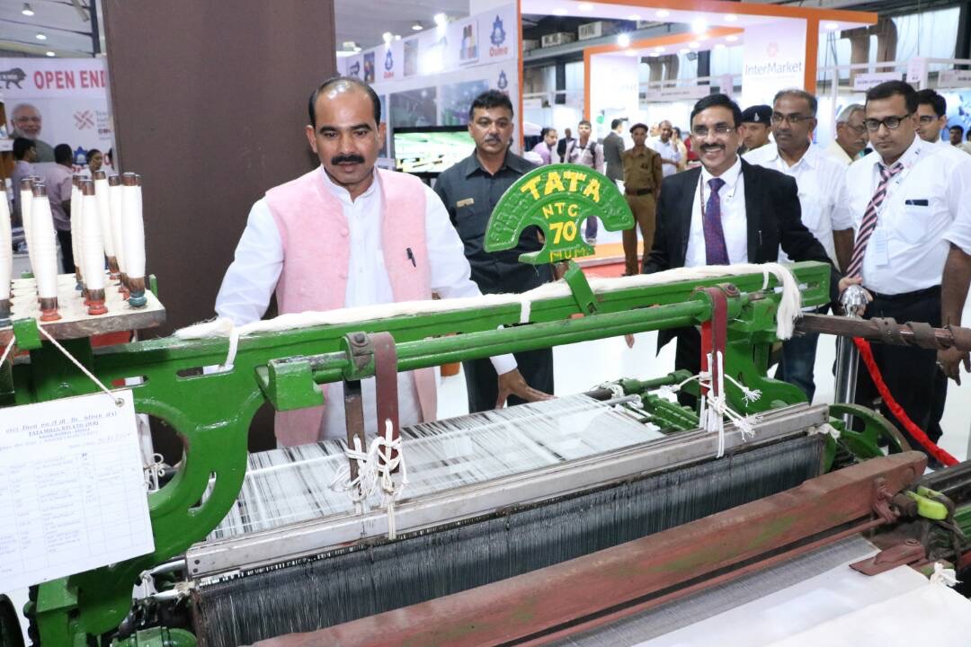 Honorable Minister of State, Shri Ajay Tamta, Ministry of Textiles, Government of India, is taking the information about machines of mill in NTC stall in Textile India 2017.